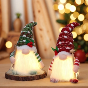 Set of two glowing Christmas gnomes with LED lights in red and green knitted hats