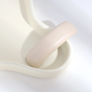 Close-up of beige PU leather hair clip showing detailed texture and elegant pleats