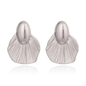 Macro shot of silver leaf-shaped earrings with textured geometric fan patterns