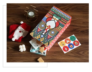 Close-up of a festive Christmas clown gift bag with colorful geometric patterns and stickers