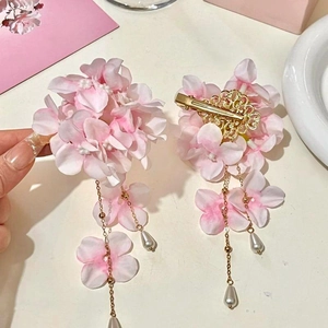 Dettaglio del fermaglio per capelli in tessuto ortensia rosa con nappe di perle