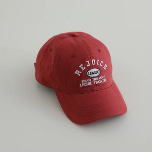 Detail view of the red cotton baseball cap with white embroidered rejoice text
