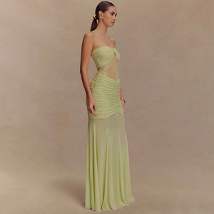 Detail of light green ruched long dress featuring lace patchwork and side silhouette