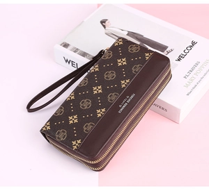 Close-up of long dark brown vintage floral wallet with double zippers and wrist strap