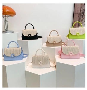 Detailed group view of colorful textured square bags with round metallic donut clasps