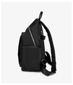 Side view of black nylon backpack with multi-layer zippers and padded shoulder straps