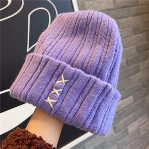Thick purple knit beanie for women with white cross-stitch trim for winter warmth