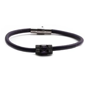 Macro view of purple braided leather bracelet with silver magnetic clasp and gemstones