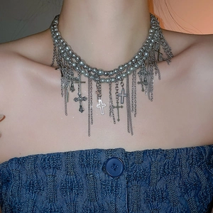 Nahaufnahme einer gotischen Perlenkette mit silbernen Kreuzanhängern und Metallketten