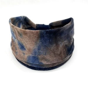 Detail of bohemian tie-dye cotton headband with soft texture in navy and brown tones