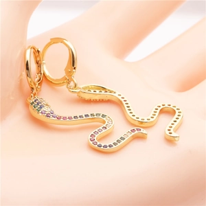 Detailed close-up of gold snake earrings with pavé colorful zircon and shell accents