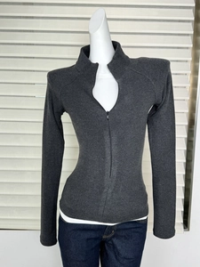 Detail of slim-fit dark grey zip-up turtle neck top with ribbed texture on a mannequin