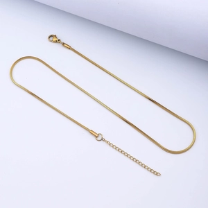 Detail view of a gold-colored stainless steel snake chain with lobster clasp and extender
