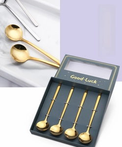 Set of four gold stainless steel round spoons in a Good Luck gift box packaging