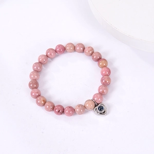 Pink zebra stone beads bracelet with a silver heart pendant on a white background