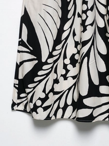 Détail du motif botanique noir et blanc sur le tissu tissé de cette jupe midi chic
