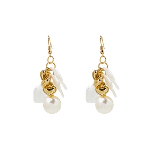Detail of French vintage earrings with white petals, pearls and gold heart charms