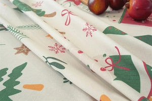 Close-up of linen fabric showing Christmas tree and gingerbread man pattern details