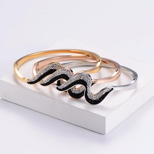 Three-piece set of wave-shaped stainless steel bracelets with black and white rhinestones