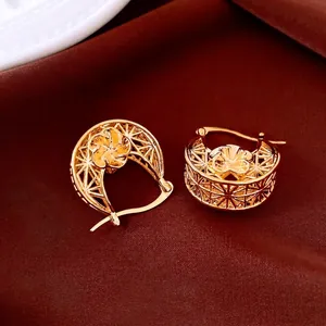 18K gold plated vintage flower hollow earrings on elegant red silk background