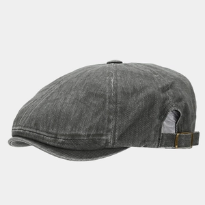 Detail of vintage grey washed newsboy cap with adjustable brass metal side buckle