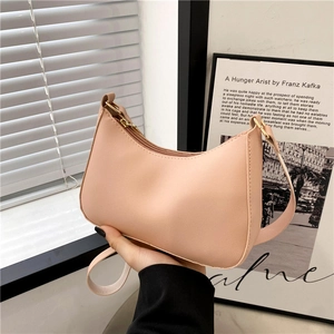 Minimalist beige moon-shaped faux leather underarm shoulder bag with gold hardware