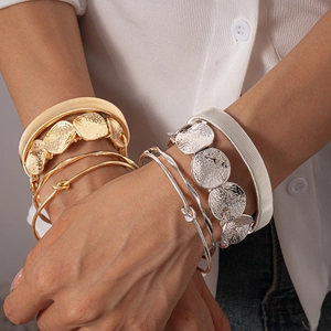Chic gold and silver stacked cuff bracelets with geometric hammered texture and mesh weave