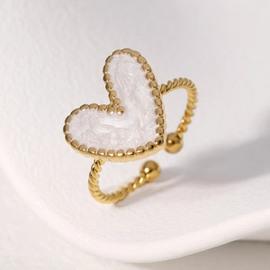 Adjustable golden stainless steel ring with a twisted band and white enamel heart charm