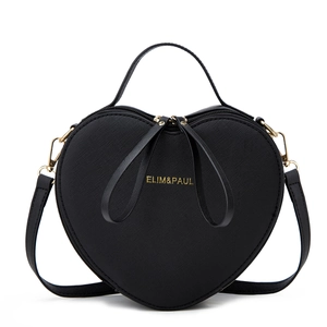 Detail of heart-shaped handbag in black Saffiano leather with gold zipper and logo