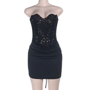 Detail van een zwarte strapless jurk met opengewerkte kant en gerimpeld bodycon ontwerp