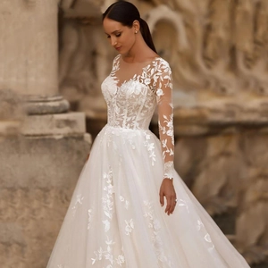 Elegant ivory long sleeve wedding dress with floral lace appliques and tulle train