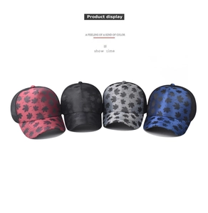 Detail view of four colored baseball caps with maple leaf prints and mesh backs