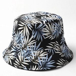 Detailed close-up of tropical palm leaf pattern on a reversible cotton bucket hat