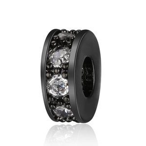 Close-up of a black copper rondelle spacer bead with white zircon stones on white background