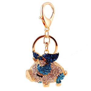 Sparkling zodiac flying pig keychain with white and blue rhinestones on gold metal plating