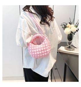 Detail of pink quilted bubble cloud bag with soft textured fabric and crossbody strap