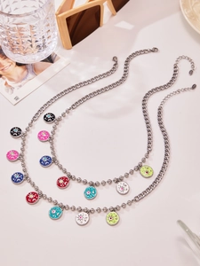 Detailed view of silver curb and bead necklaces with colorful celestial enamel pendants