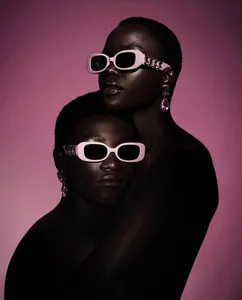 Detailed view of pink rectangular sunglasses with purple crystal-studded temples