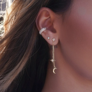 Close-up of S925 silver star and moon tassel earrings with gold plating on model ear