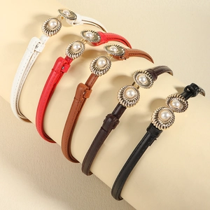 Five thin leather waist belts in assorted colors featuring pearl and gold buckles