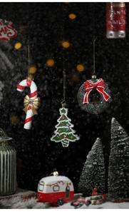 Festive Christmas ornaments featuring candy canes and mini campers for tree decoration
