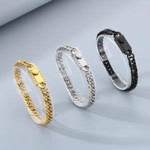 Curb chain bracelet set in gold, silver and black finishes with gear patterned buckle