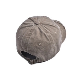 Detail showing the adjustable metal buckle and distressed fabric on the vintage baseball cap