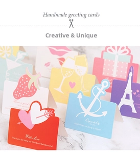 Detailed close-up of handmade 3D heart and Eiffel Tower greeting cards with gold foil text