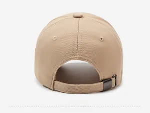 Detail view of the beige baseball cap rear with adjustable metal buckle and textured fabric