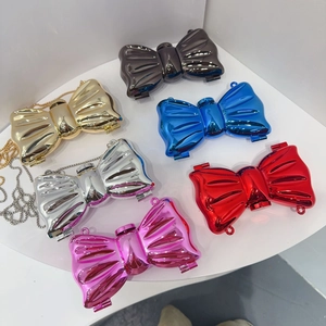 Mini acrylic bow clutches in metallic gold, silver, pink, and blue with chain straps