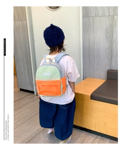 Kid model showing back view of the color-block canvas backpack for ages 3-6