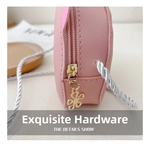 Detailed close-up of pink PU leather kitty bag featuring a golden flower zipper and rope strap