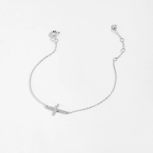 Detail of S925 sterling silver cross bracelet featuring sparkling zircon accents and clasp