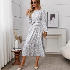 Detail of elegant bishop sleeves and ruffles on beige geometric print long dress